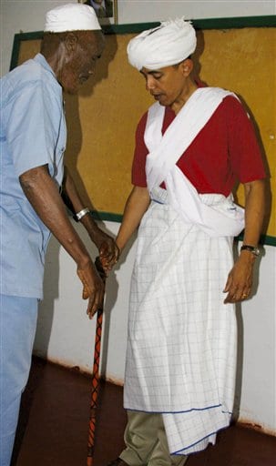 Sen. Barack Obama, D-Ill., right, is dressed as a Somali Elder by Sheikh Mahmed Hassan, left, during his visit to Wajir, a rural area in northeastern Kenya, near the borders with Somalia and Ethiopia in this file photo from Aug. 27, 2006. The garb was presented to Obama by elders in Wajir. Obama’s estranged late father was Kenyan and Obama visited the country in 2006, attracting thousands of well-wishers. (AP photo and caption.)