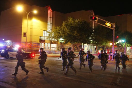 Riot police respond to anti-Trump protests following a rally and speech by Republican presidential candidate Donald Trump, in front of the Albuquerque Convention Center where the event was held, in Albuquerque, N.M., Tuesday, May 24, 2016. (AP Photo/Brennan Linsley)