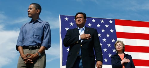 Democratic Presidential candidates and U.S. Senator Barack Obama (D-IL) (L), Bill Richardson (C), Governor of New Mexico and U.S. Senator Hillary Clinton (D-NY) stand for the National Anthem during the 30th annual Harkin Steak Fry in Indianola, Iowa, September 16, 2007. (Reuters/Joshua Lott.)